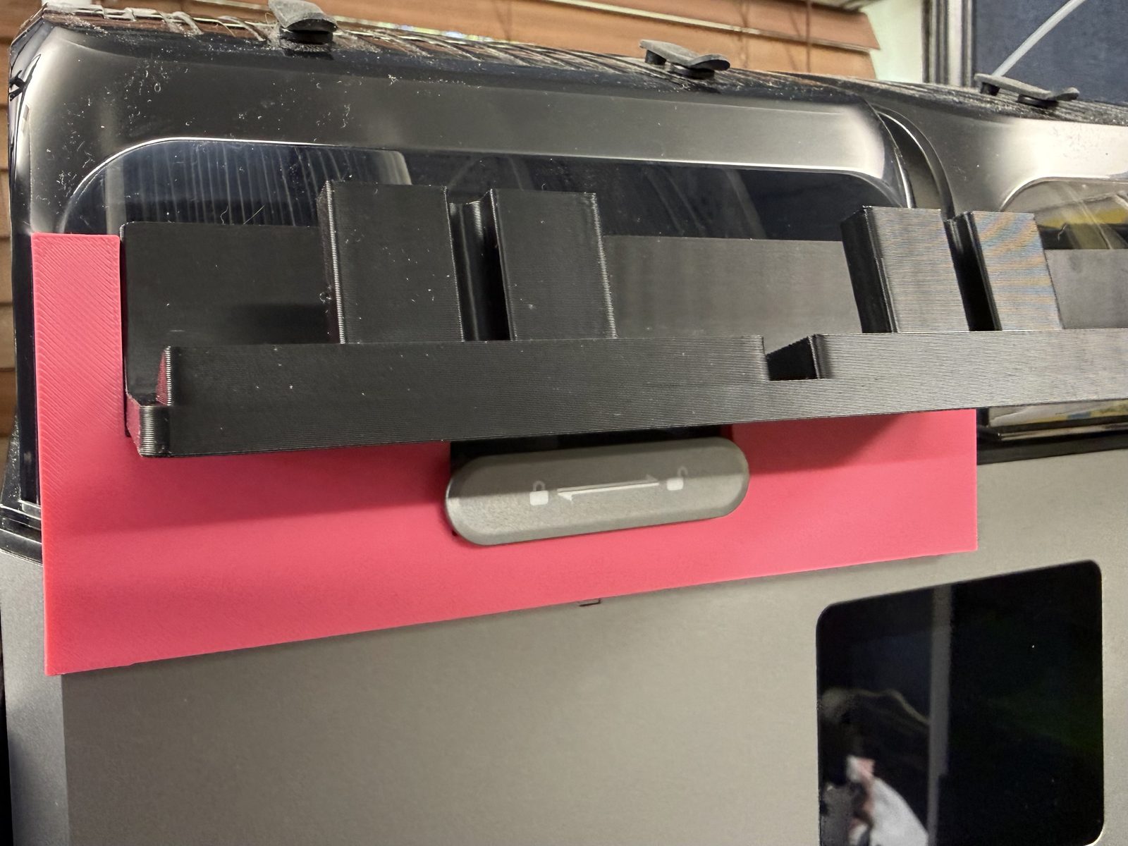 Pink template fitted on the locking latch of a Creality SpacePi X4, with black two-post holders sitting on top of it